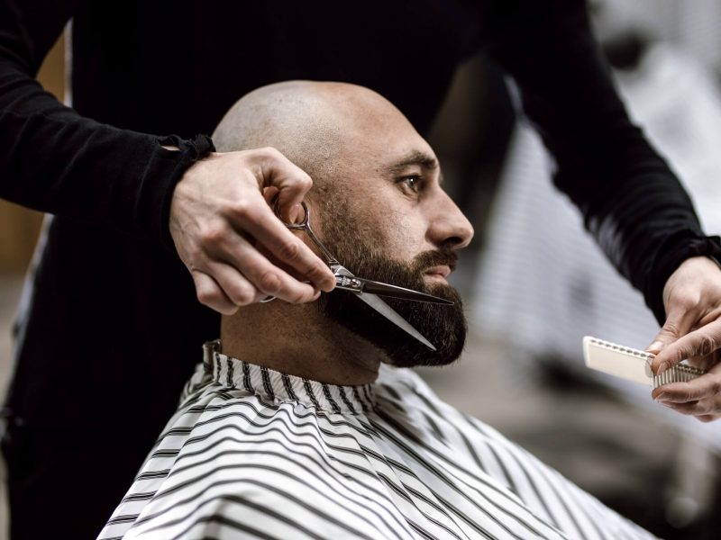 fashion-barber-dressed-in-a-black-clothes-scissors-beard-of-brutal-man-in-the-stylish-barbershop.jpg